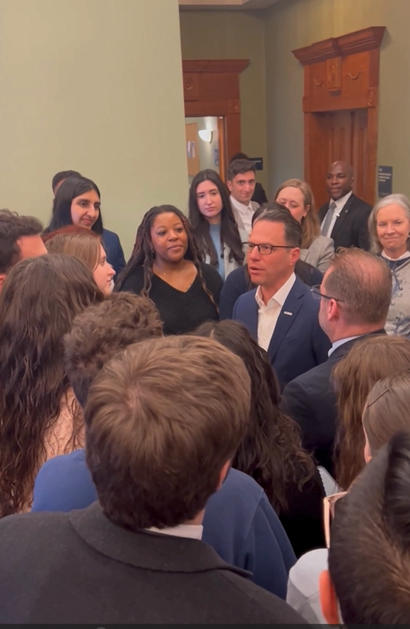 Governor Josh Shapiro standing outside the Deans' Gallery surrounded by Widener Law Commonwealth Students