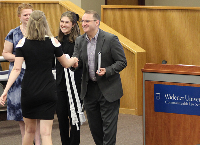 Image of Megan Bisco getting her cords for the student awards ceremony.