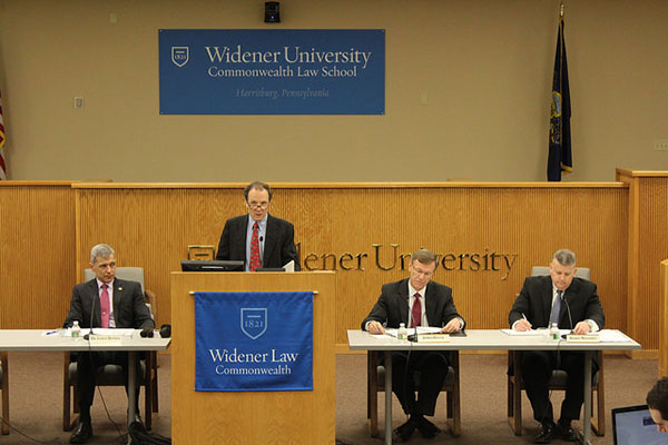 Photo of speakers at a symposium