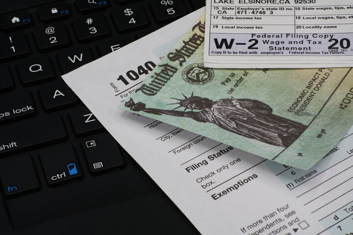 Image of W2 and tax documents laid out on a table.