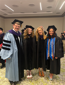 Image of Professor Christian Johnson, Alyssa Flannery '24, Professor Michal Buchhandler-Raphael and Kira Flannery '26 at commencement. 