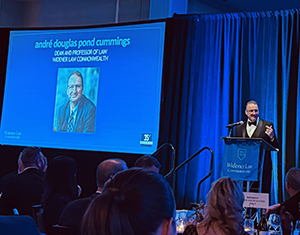 Image of Dean cummings speaking at the podium at the 35th Anniversary Gala.