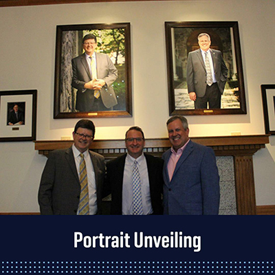 Image of Deans Christian Johnson, andre douglas pond cummings and Michael Hussey standing in the Deans Gallery before their portraits. 