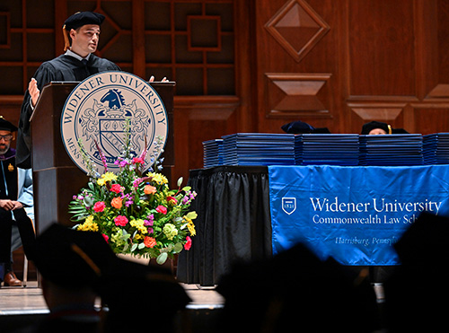 Pennsylvania Attorney General Dave Sunday speaking at the podium on stage at commencement. 