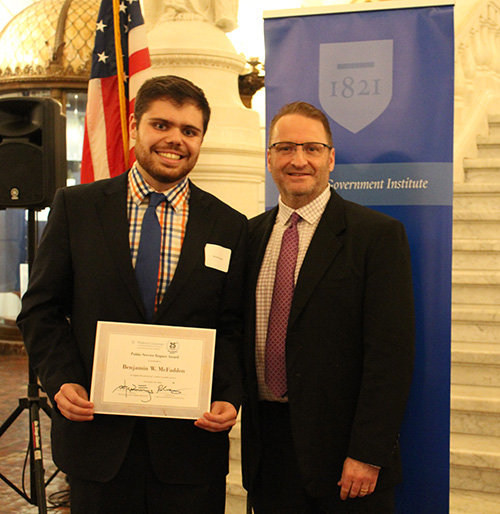 Ben McFadden pictured with Dean cummings with an American flag behind them. 