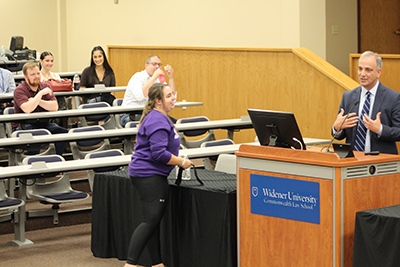 1L Audrey Confer receiving the Tinker Vietnam War armband from Judge Bianco. 