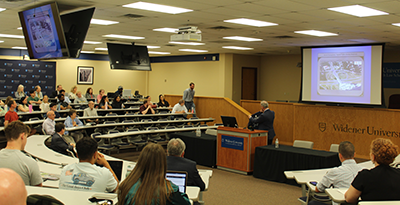 1L George Anderson walking up to receive his camp T-shirt from Judge Bianco.