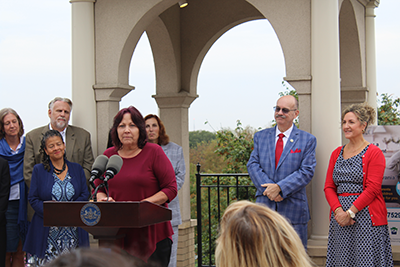 Image of Deborah Myers speaking at the Sept. 2025 press event.