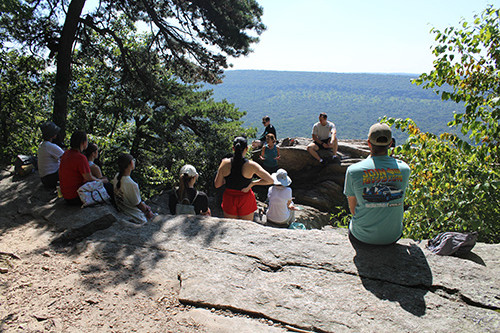 Image of students and faculty sitting at Table Rock on the Appalachian Trail, overlooking Clarks Valley. 
