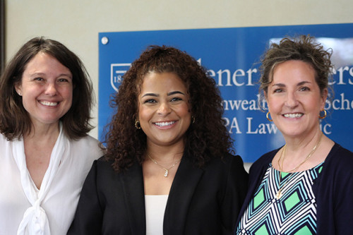 Vanessa Peck stands with Prof. Rebecca Waldemar and Mary Catherine Scott in front of the Central PA Law Clinic with her award. 