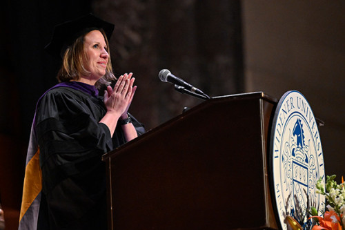 Image of Judge Keli Neary delivering remarks during commencement at the podium at the forum. 
