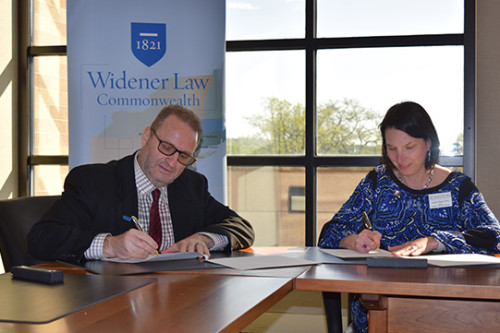 Dean cummings singing the 3+3 agreement with the University of Scranton. 