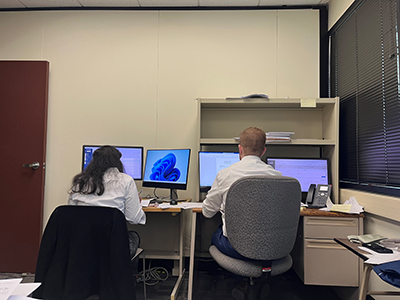 Student externs working behind computers at the Dauphin County Domestic Relations.