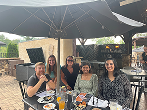 Group photo of Amanda LaPiccolo with her student externs at an event. 