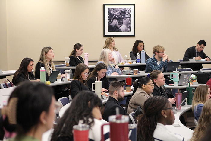 Image of crowd inside A180 listening to the Law Review Symposium