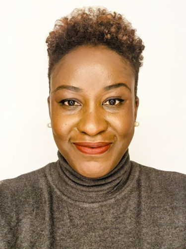 Image of Bunmi Emenanjo, A woman with short hair wearing a turtle neck sweater, exuding a stylish and modern appearance.