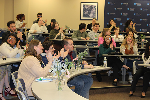 Image of crowd sitting in the Douglas M. Wolfberg Courtroom during the Public Interest Auction. 