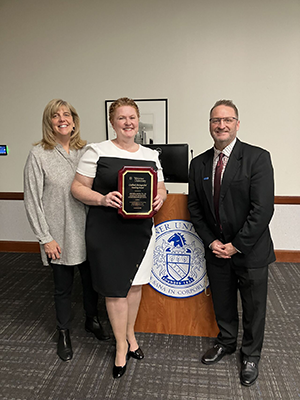 Prof. Anna Hemingway standing with Prof. Amanda Sholtis and Dean cummings. 