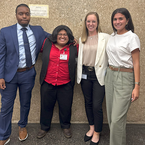 Image of Andrea Hernandez-Rodriguez standing in a group photo with her Camp 1L interns. 