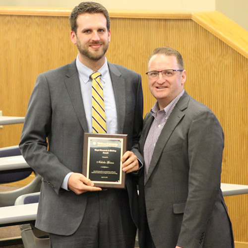 Nick Grimes stands with Dean cummings in A180 with his award. 