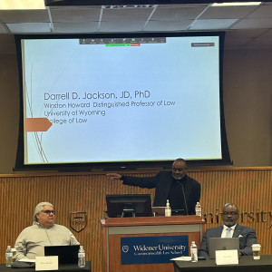 Professor Darrell Jackson speaking at Widener Law Commonwealth behind a podium. 