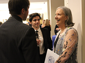 President Stacey Robertson talking with students at the gala.