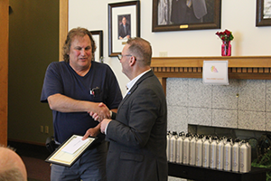 Image of Bob Dolbin shaking hands with Dean cummings. 