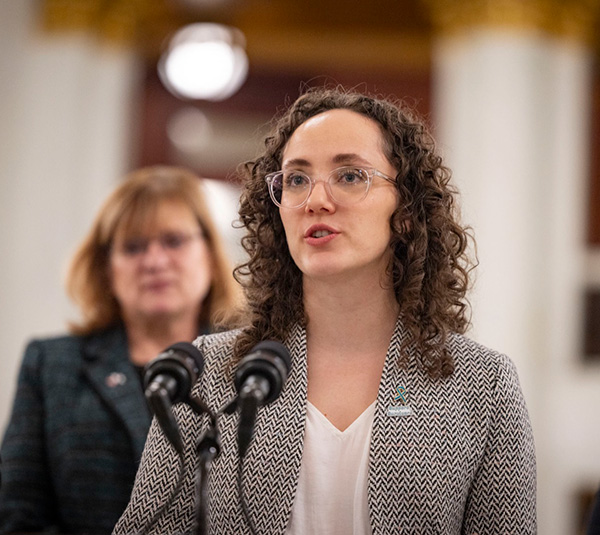 Photo of Romeo at a podium speaking.