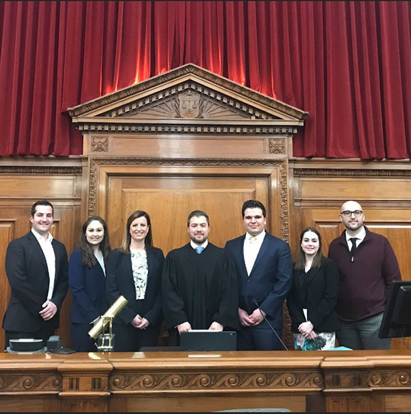 Photo of Mike with the winning mock trial team and their coaches