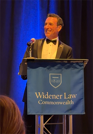 Doug Wolfberg Speaking at the Podium.