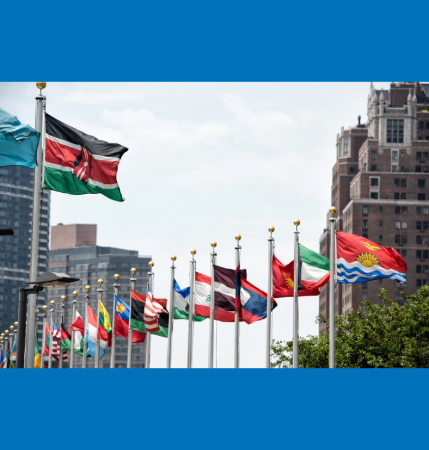 An array of international flags, possibly outside the United Nations headquarters. 