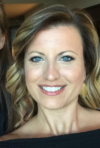 Amy Bua smiles in a close-up portrait.