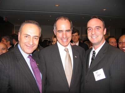 Photo of alumnus standing shoulder-to-shoulder with colleagues