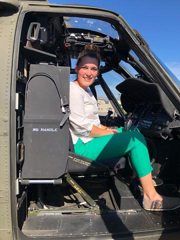 Carolyn Dreer — Carolyn Dreer sits smiling in the cockpit of a military helicopter at Fort Rucker, Alabama, during her externship with the U.S. Army Judge Advocate General's Corps.