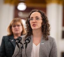 Photo of alumnus speaking into microphones