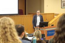 Professor Stephen Vladeck speaking at podium in the Wolfberg Courtroom. 