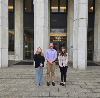 WLC alumnus Mark with two students during a Moot Court competition.