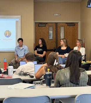 Panel of students at the front of the classroom